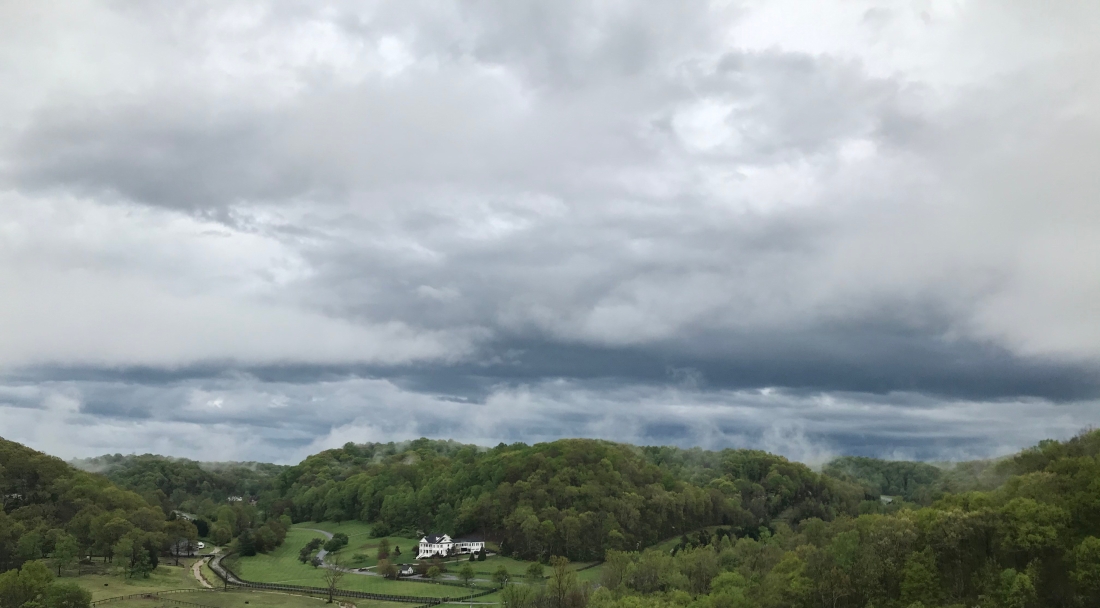 Dark clouds over the green countryside